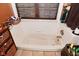 A clean bathtub under a window with a blind at 114 E 27Th St, Indianapolis, IN 46205