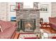 Close-up of a brick fireplace with decorative mantle, framed artwork, and zebra art at 114 E 27Th St, Indianapolis, IN 46205