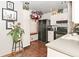 Well-lit kitchen with black appliances, white cabinets, and decorative accents at 114 E 27Th St, Indianapolis, IN 46205
