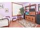Cozy living room with patterned rug, a TV, and a comfortable chair at 114 E 27Th St, Indianapolis, IN 46205