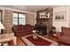 Inviting living room with a brick fireplace, classic furnishings, and bright windows at 114 E 27Th St, Indianapolis, IN 46205