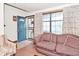 Living area with a comfortable couch, large window, and a decorative front door at 114 E 27Th St, Indianapolis, IN 46205