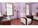 Cozy living room with a cream chair, wood trim windows, and light purple walls at 114 E 27Th St, Indianapolis, IN 46205