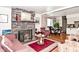 Inviting living room with a brick fireplace, plush seating, and hardwood floors at 114 E 27Th St, Indianapolis, IN 46205