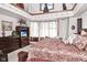Large bedroom featuring elegant furniture, bright windows, and neutral carpeting at 114 E 27Th St, Indianapolis, IN 46205