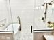 Glass enclosed shower features an overhead rain shower head and hexagon mosaic tile flooring at 114 S Walnut St, Muncie, IN 47305