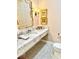 Chic bathroom features a marble countertop, decorative mirror, and patterned tile floor at 114 S Walnut St, Muncie, IN 47305