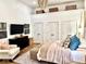 Bedroom with high ceilings, a contemporary light fixture, and ample closet space at 114 S Walnut St, Muncie, IN 47305