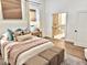 Bright bedroom leading into the bathroom, showcasing hardwood floors and light decor at 114 S Walnut St, Muncie, IN 47305