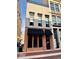 View of the building's stylish brick exterior with black awnings and large windows at 114 S Walnut St, Muncie, IN 47305