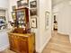 Hallway decor with a wooden cabinet and various art pieces at 114 S Walnut St, Muncie, IN 47305