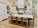 Modern kitchen features a large island with seating, pendant lighting, and stainless steel appliances at 114 S Walnut St, Muncie, IN 47305