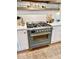 Close up of gourmet range with gray blue finish, brass accents and pot filler faucet at 114 S Walnut St, Muncie, IN 47305