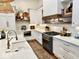 Bright, modern kitchen showcasing white cabinetry, quartz countertops, and stainless steel appliances at 114 S Walnut St, Muncie, IN 47305