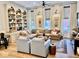 Bright living room featuring a large sectional, built-in shelves, and stylish decor at 114 S Walnut St, Muncie, IN 47305