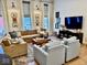 Cozy living room with a large sectional, accent chairs, and ample natural light at 114 S Walnut St, Muncie, IN 47305