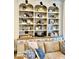 Close up of white built-ins with arch design, wood countertop, and decor in staged living room at 114 S Walnut St, Muncie, IN 47305