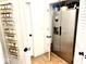 Walk-in pantry with vertical spice rack, stainless steel refrigerator, and organized storage solutions at 114 S Walnut St, Muncie, IN 47305