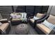 Relaxing outdoor seating area with comfortable wicker furniture and stylish decor at 114 S Walnut St, Muncie, IN 47305