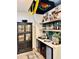 Wet bar with shelving, bar fridge, sink, and drinkware cabinet, perfect for entertaining at 114 S Walnut St, Muncie, IN 47305