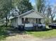 Quaint one-story home featuring a covered front porch and charming curb appeal at 1221 E 22Nd St, Anderson, IN 46016