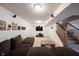 Finished basement with carpet, a large dark couch, TV, stairs and speakers at 12493 Loudoun Pl, Fishers, IN 46037