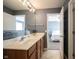 Bathroom featuring double sinks, a large mirror, tile flooring, and an entrance to the bedroom at 12493 Loudoun Pl, Fishers, IN 46037
