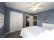 Bedroom featuring blue walls, carpet flooring, a queen-sized bed, and ensuite bathroom entrance at 12493 Loudoun Pl, Fishers, IN 46037