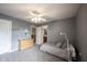 Bedroom featuring gray walls, carpet flooring, a twin-sized bed, and ensuite bathroom entrance at 12493 Loudoun Pl, Fishers, IN 46037