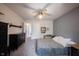 This bedroom features neutral paint, carpet, a ceiling fan, and natural light at 12493 Loudoun Pl, Fishers, IN 46037