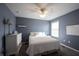 Bedroom featuring blue walls, carpet flooring, a queen-sized bed, and a ceiling fan with integrated lighting at 12493 Loudoun Pl, Fishers, IN 46037