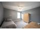 Bedroom featuring gray walls, carpet flooring, a twin-sized bed, and a ceiling fan with integrated lighting at 12493 Loudoun Pl, Fishers, IN 46037