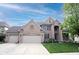 Charming brick two-story home with attached two-car garage and well-maintained lawn at 12493 Loudoun Pl, Fishers, IN 46037