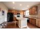 Kitchen with wooden cabinetry, central island, and modern appliances at 12493 Loudoun Pl, Fishers, IN 46037