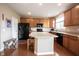 Kitchen with wooden cabinetry, central island, and modern appliances at 12493 Loudoun Pl, Fishers, IN 46037