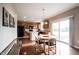 Kitchen with adjoining dining area, wooden cabinets, and sliding glass door at 12493 Loudoun Pl, Fishers, IN 46037