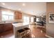 Open kitchen with an island, wooden cabinets, and an adjacent dining area at 12493 Loudoun Pl, Fishers, IN 46037