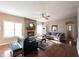 Living room with hardwood floors, brick fireplace, ceiling fan, and lots of natural light at 12493 Loudoun Pl, Fishers, IN 46037