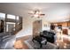 Open concept living room has hardwood floors, a ceiling fan, stairs, and view to the kitchen at 12493 Loudoun Pl, Fishers, IN 46037