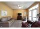 Comfortable living room with a ceiling fan, neutral carpet, and lots of sunlight at 12493 Loudoun Pl, Fishers, IN 46037