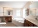 This main bathroom features a large soaking tub, dual vanities and a large window at 12493 Loudoun Pl, Fishers, IN 46037