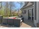 Outdoor deck area with a cozy seating area and a TV mounted on the exterior of the house at 12608 E 86Th St, Indianapolis, IN 46236