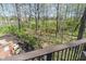 Scenic backyard view with a small creek, lush trees, and a privacy fence at 12608 E 86Th St, Indianapolis, IN 46236