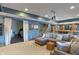 Basement featuring a gray sectional sofa, wet bar, staircase, and exercise room, offering ample space for relaxation and recreation at 12608 E 86Th St, Indianapolis, IN 46236