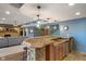 Open basement bar with stone accents, wood cabinets, and a mini fridge, ideal for hosting gatherings at 12608 E 86Th St, Indianapolis, IN 46236