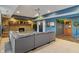 Finished basement boasts a stone fireplace, comfortable gray sectional, and bar area, ideal for relaxation and entertainment at 12608 E 86Th St, Indianapolis, IN 46236