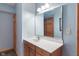 Bright bathroom featuring a clean vanity with wood cabinets, white countertops, and a large mirror at 12608 E 86Th St, Indianapolis, IN 46236
