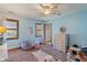 Light blue bedroom featuring two windows, ceiling fan, a white dresser, and decorative accents for a cozy, inviting space at 12608 E 86Th St, Indianapolis, IN 46236