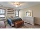 Bedroom featuring a ceiling fan, dresser, wood shelving, and carpeted floor at 12608 E 86Th St, Indianapolis, IN 46236