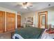 Bedroom featuring a desk area, ceiling fan, and three wood doors at 12608 E 86Th St, Indianapolis, IN 46236